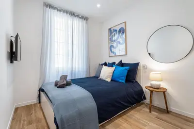 a bedroom with a large blue bed with a mirror at Nice Renting - REPUBLIQUE - Garibaldi Chic 3 Bedrooms 3 Bathrooms Balcony AirCon in Nice