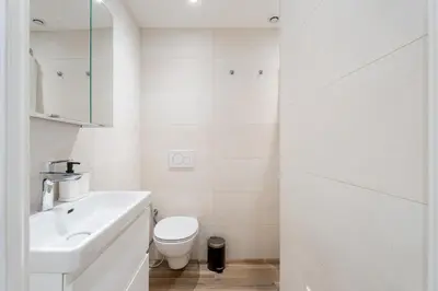 a white bathroom with a toilet and a sink at Nice Renting - REPUBLIQUE - Garibaldi Chic 3 Bedrooms 3 Bathrooms Balcony AirCon in Nice