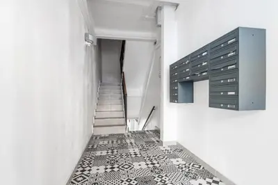 a hallway with a staircase and a tile floor at Nice Renting - REPUBLIQUE - Garibaldi Chic 3 Bedrooms 3 Bathrooms Balcony AirCon in Nice