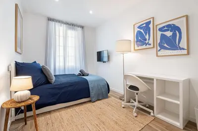 a bedroom with a blue bed and a desk at Nice Renting - REPUBLIQUE - Garibaldi Chic 3 Bedrooms 3 Bathrooms Balcony AirCon in Nice