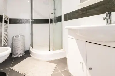a white bathroom with a sink and a shower at Le Malausséna in Nice