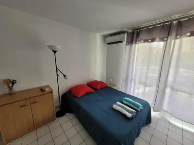 a bedroom with a bed with towels on it at Studio climatisation balcon à 5 min de la plage in Nice