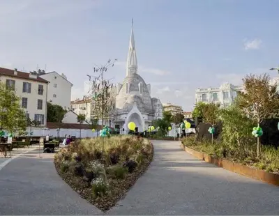 a building with a spire in the middle of a street at Jeanne Darc in Nice