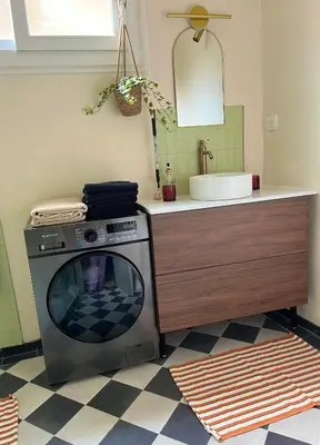 a bathroom with a sink and a washing machine at Jeanne Darc in Nice