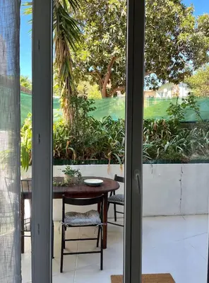 a room with a table and chairs and a window at Jeanne Darc in Nice