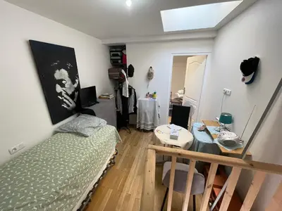 a bedroom with a bed and a table in it at Room in city Nice in Nice
