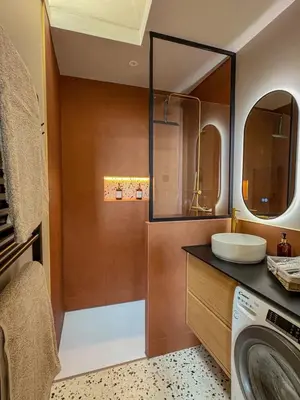 a bathroom with a sink and a washing machine at Charmant 2 pièces rénové avec vue mer in Villefranche-sur-Mer