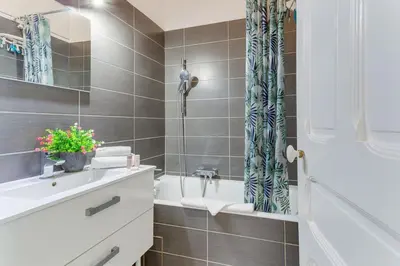 a bathroom with a white tub and a sink at LE CONCORDIA AP4478 by RIVIERA HOLIDAY HOMES in Nice