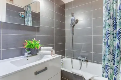 a bathroom with a tub and a toilet and a sink at LE CONCORDIA AP4478 by RIVIERA HOLIDAY HOMES in Nice