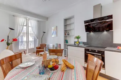 a kitchen and dining room with a table with food on it at LE CONCORDIA AP4478 by RIVIERA HOLIDAY HOMES in Nice