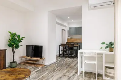 a living room with a tv and a table at Ultra Central Rue Massena 1 Bdr in Nice