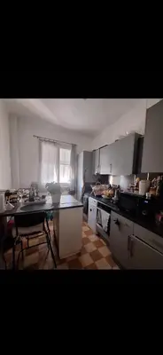 a kitchen with a counter and a table in it at Magnifique appartement a la mer in Nice