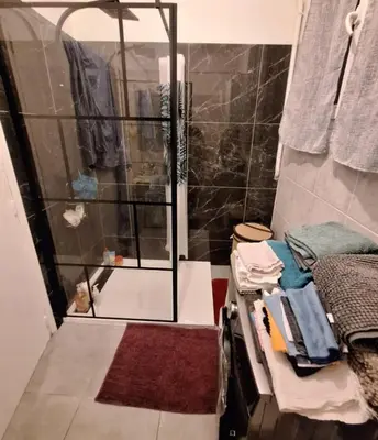 a shower with a glass door in a bathroom at Magnifique appartement a la mer in Nice