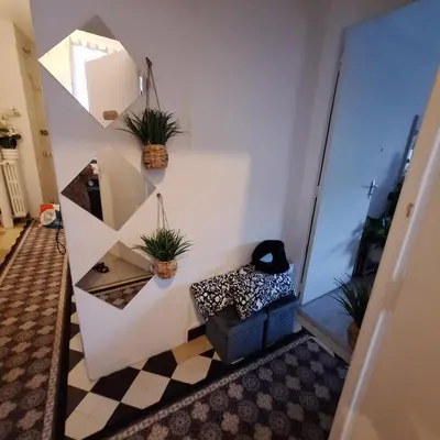 a hallway with potted plants on the wall at Magnifique appartement a la mer in Nice