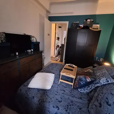 a bedroom with a bed with a table on it at Magnifique appartement a la mer in Nice