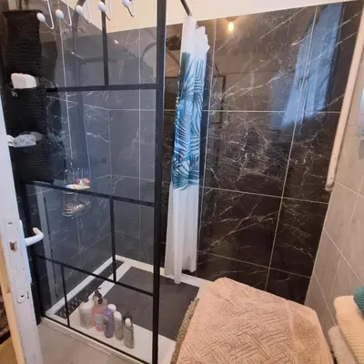 a bathroom with a shower with a glass door at Magnifique appartement a la mer in Nice