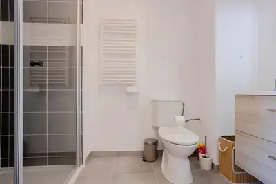 a bathroom with a toilet and a glass shower at Nice 2 pièces charmant proche port et transports in Nice