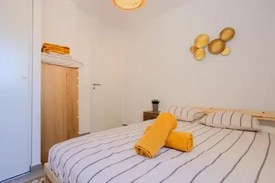 a bedroom with a bed with yellow towels on it at Nice 2 pièces charmant proche port et transports in Nice