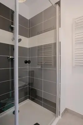 a shower with a glass door in a bathroom at Nice 2 pièces charmant proche port et transports in Nice