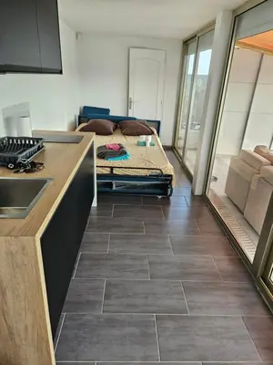 a kitchen with a bed in the middle of a room at Logement vue mer - Nice ouest in Nice