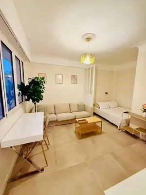 a living room with a couch and a table at Beach and Sun two minutes away in Nice