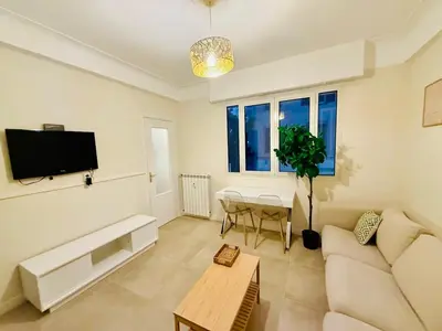 a living room with a couch and a table at Beach and Sun two minutes away in Nice
