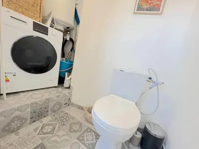 a bathroom with a toilet and a microwave at ⁂ Cocon ensoleillé proche de la plage in Nice