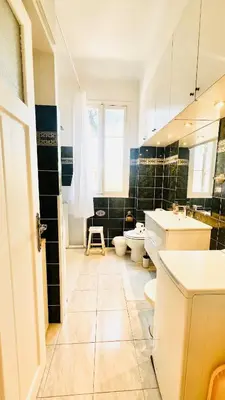 a bathroom with two toilets and a sink at Sublime 2 bedroom spacious and bright AC Private parking in Nice