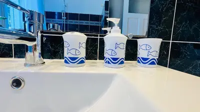four blue and white vases sitting on a bathroom sink at Sublime 2 bedroom spacious and bright AC Private parking in Nice