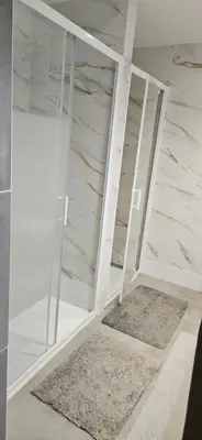 a room with glass shelves and a marble wall at Villa Nanou Riviera in Nice