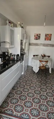a kitchen with a sink and a table in it at Villa Nanou Riviera in Nice