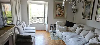 a living room with a white couch and a window at Villa Nanou Riviera in Nice