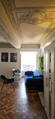a living room with a blue couch and a window at Villa Nanou Riviera in Nice