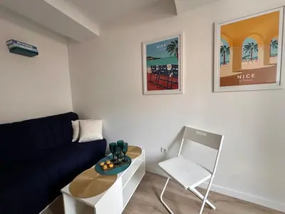 a living room with a couch and a chair at Appartement rénové Vieux Nice in Nice
