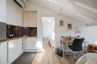 a kitchen and dining room with a table and chairs at Charme et confort - Nice Centre Libération in Nice