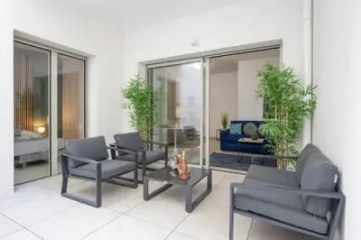a living room with chairs and a table and a couch at Appartement neuf - Patio intérieur - Parking - EF in Èze