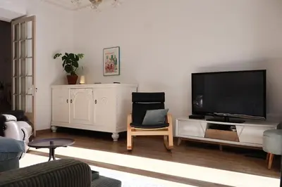 a living room with a flat screen tv on a wall at Close to sea center apartment 130m2 in Nice