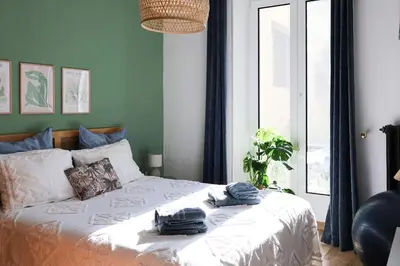 a bedroom with a bed with towels on it at Close to sea center apartment 130m2 in Nice
