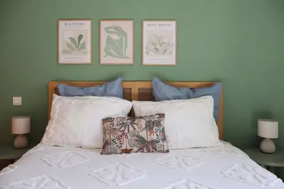 a bedroom with a bed with three pictures on the wall at Close to sea center apartment 130m2 in Nice