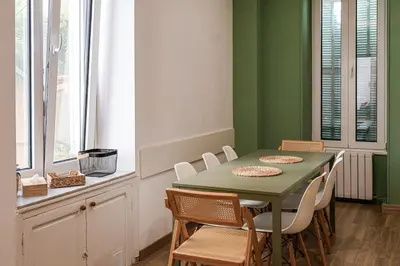 a green dining room with a table and chairs at Close to sea center apartment 130m2 in Nice