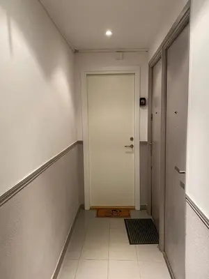 a hallway with a white door and a tile floor at Plage et Salsa, Nice Promenade des anglais in Nice
