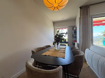 a dining room with a table and chairs at MONT BORON PALMS AP4480 by Riviera Holiday Homes in Nice
