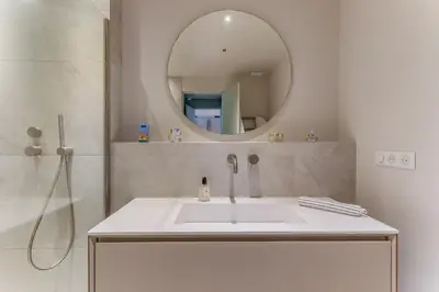 a bathroom with a white sink and a mirror at MONT BORON PALMS AP4480 by Riviera Holiday Homes in Nice