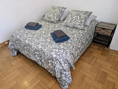 a bed with two pillows on it in a bedroom at Bel appartement proche centre 15 minutes in Nice