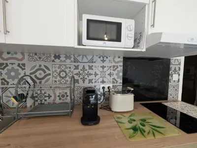 a kitchen with a counter top with a microwave at Bel appartement proche centre 15 minutes in Nice