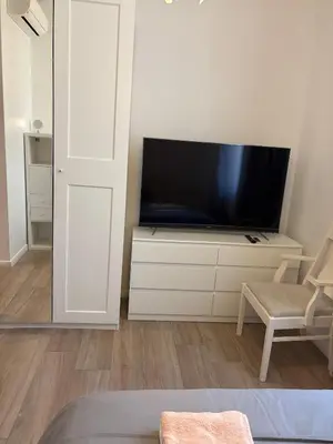 a living room with a flat screen tv on a white cabinet at Renovated F3 Parking Clim Nice Mont Boron in Nice