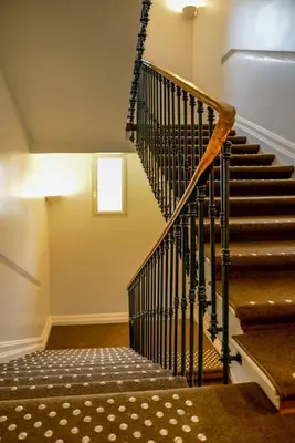 a staircase in a building with a stair case at Hôtel & Appartements Monsigny in Nice