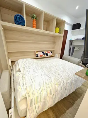 a bedroom with a bed with a wooden headboard at Studette tout équipée centre ville de Nice in Nice