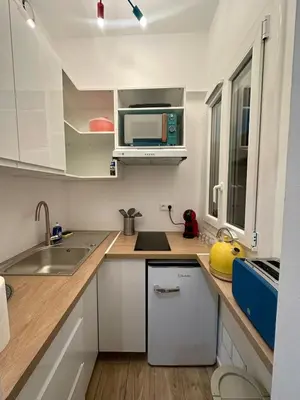 a small kitchen with a sink and a microwave at Studette tout équipée centre ville de Nice in Nice