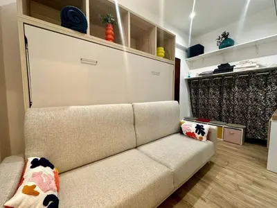 a living room with a couch with pillows at Studette tout équipée centre ville de Nice in Nice